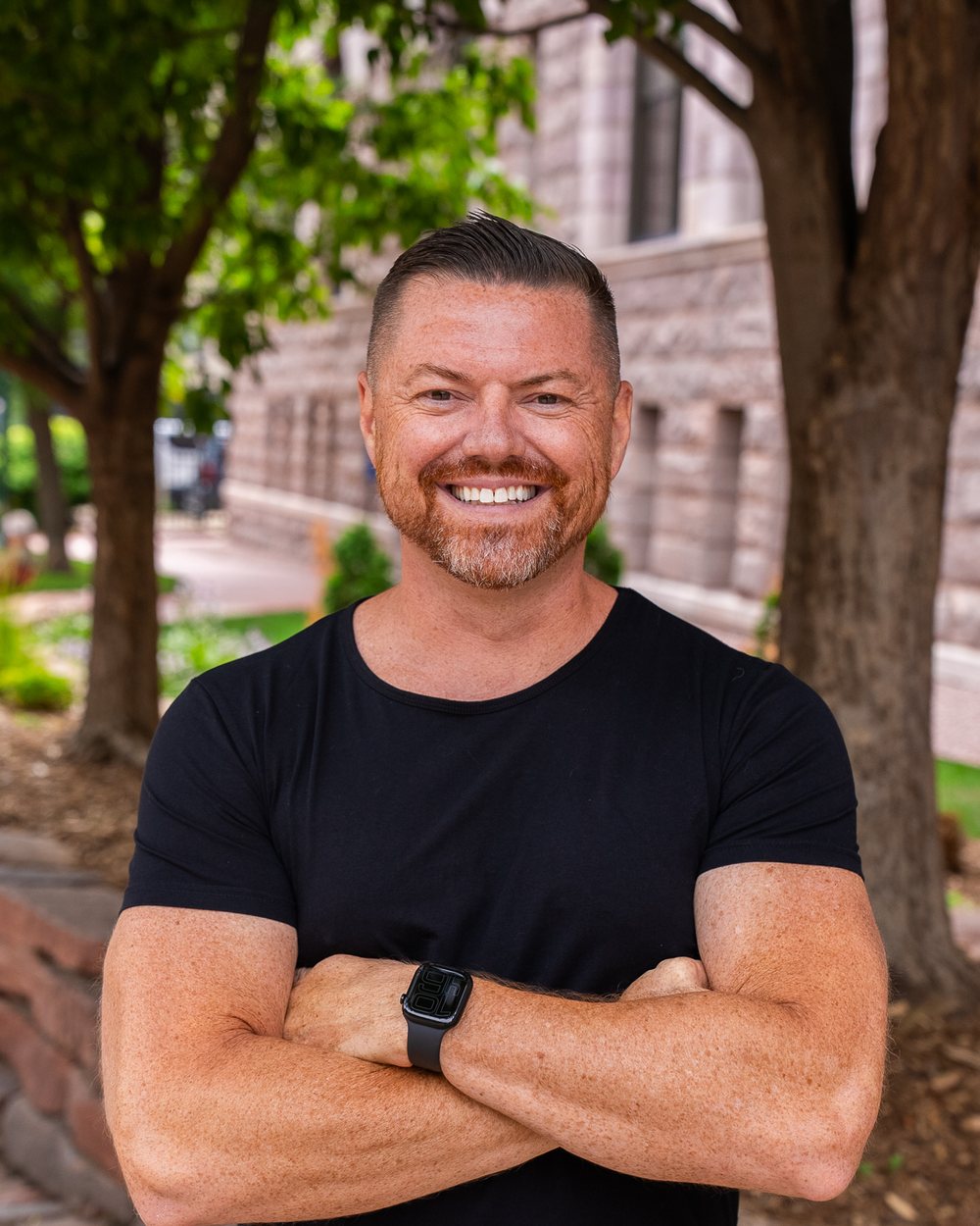Brian Rand smiling with arms crossed