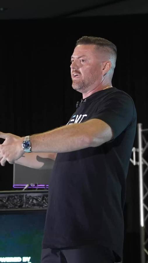 Brian Rand speaking on stage